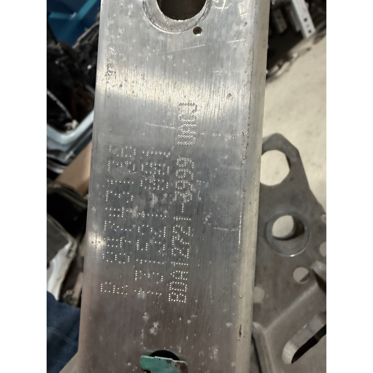 Second close-up of original stamped markings on the GM OEM suspension crossmember