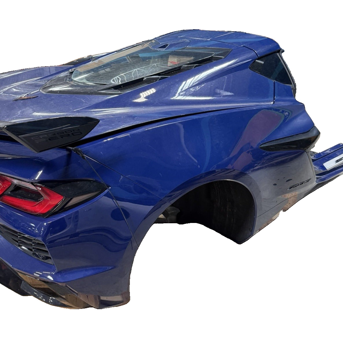 Chevrolet Corvette C8 Z06 blue rear clip assembly showing rear quarter panel, taillamp, fascia and high-wing spoiler