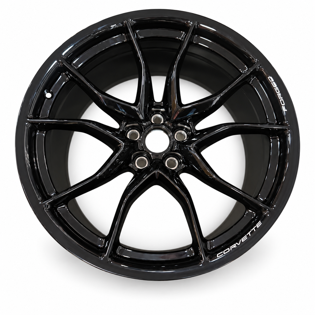 Gloss-black Chevrolet Corvette forged wheel front face, seven split spokes and uncovered center bore