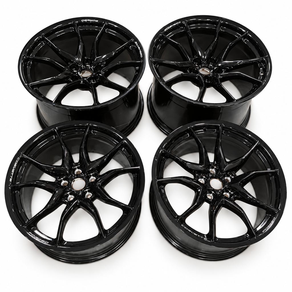 Four gloss-black Chevrolet Corvette forged wheels, two front and two rear, without tires or center caps