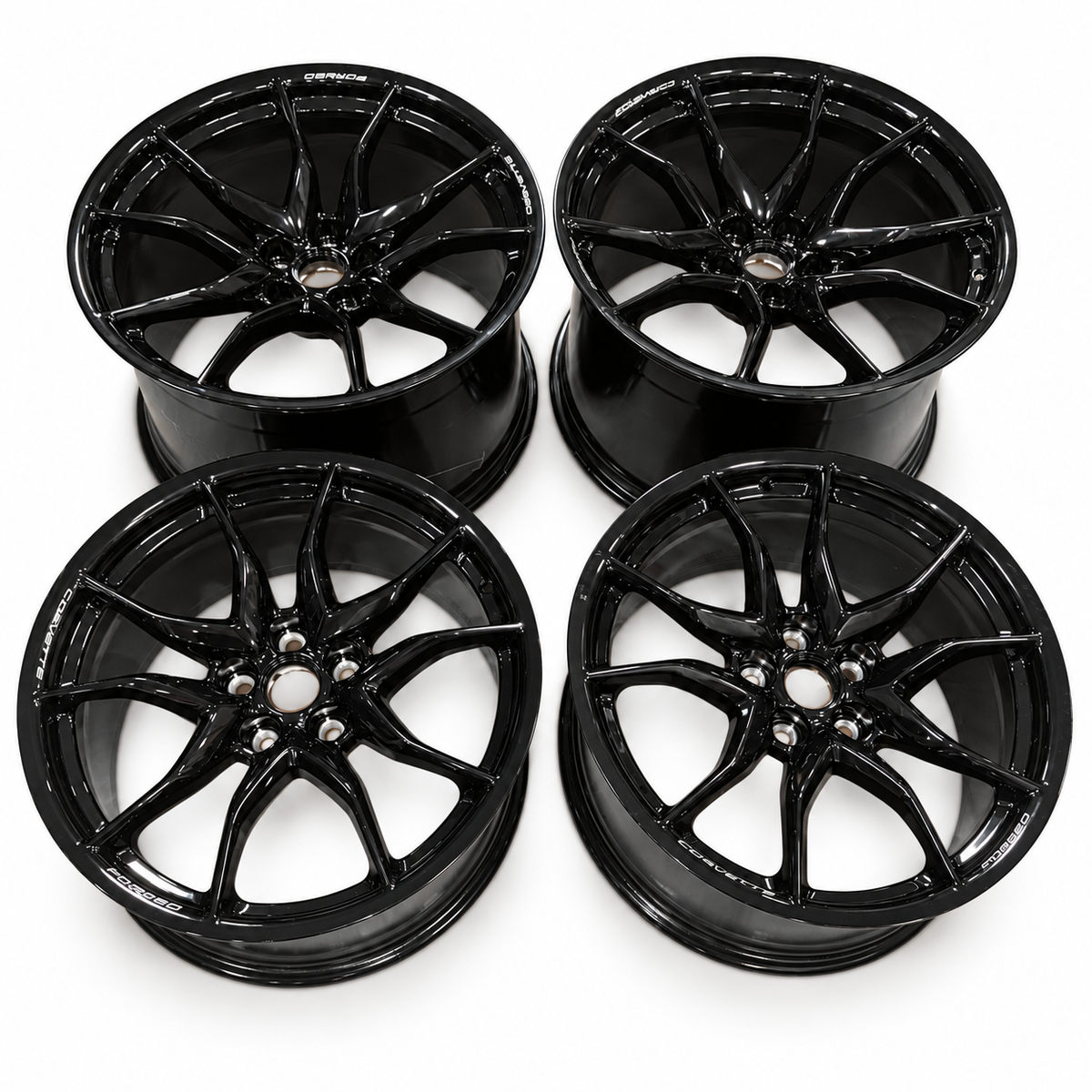 Four gloss-black Chevrolet Corvette forged wheels, two front and two rear, without tires or center caps